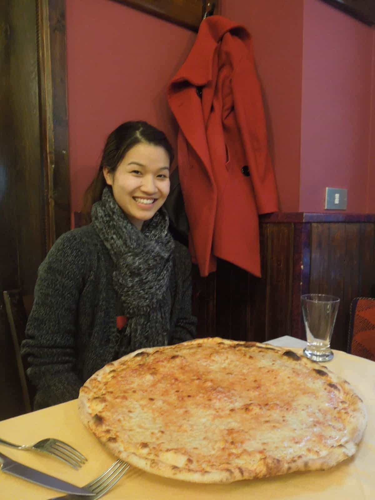 A Winter Weekend in Milan, Italy 3 Carlie posing with a huge pizza in Milan, Italy
