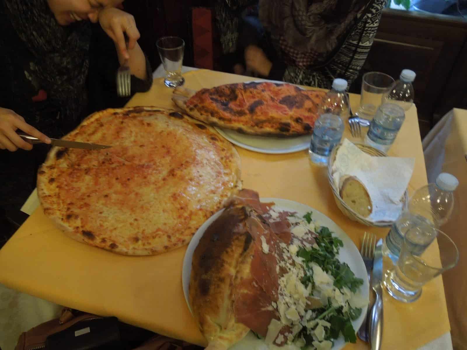A Winter Weekend in Milan, Italy 4 Giant pizzas and calzones on the table