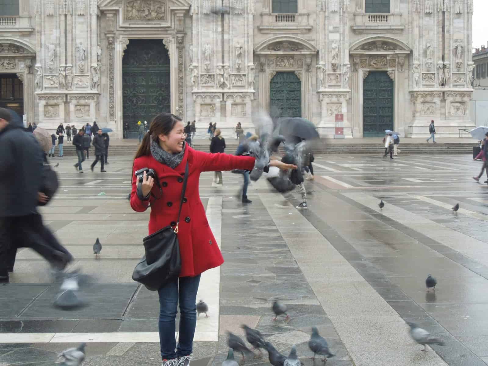 A Winter Weekend in Milan, Italy 6 Carlie feeding pigeons outside the Milano Duomo