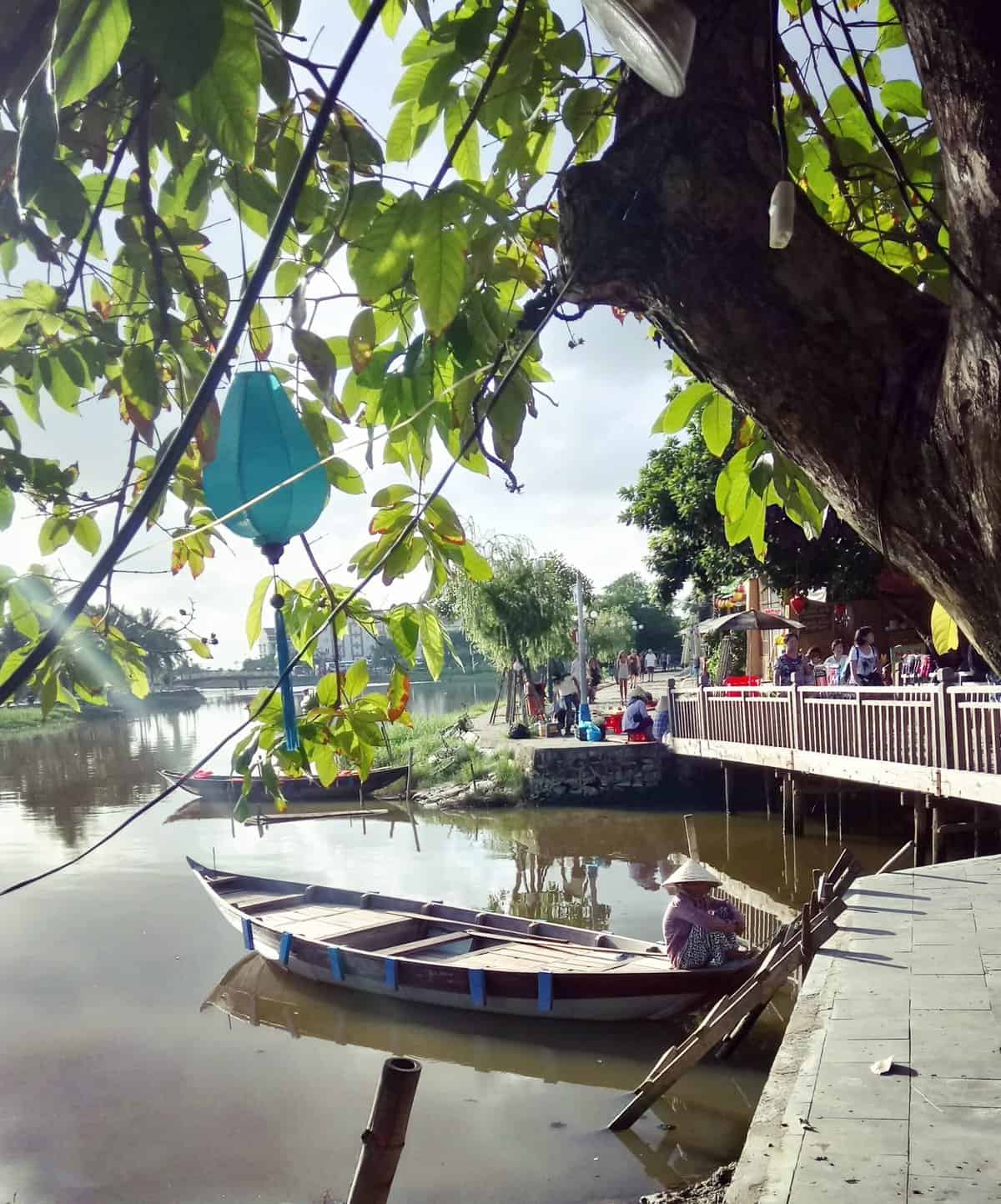 The Disneyland of Vietnam: Hoi An 4 Lanterns over the water with a small boat in Hoi An