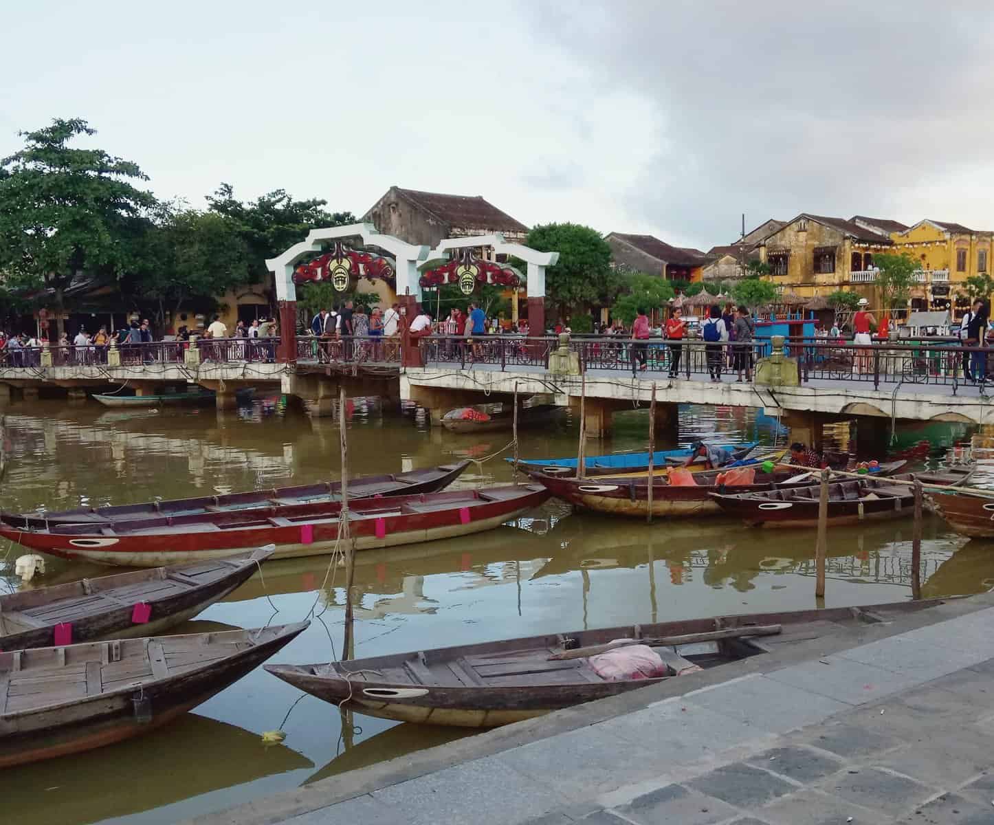 The Disneyland of Vietnam: Hoi An 3 Boats and a bridge over the water in Hoi An, Vietnam
