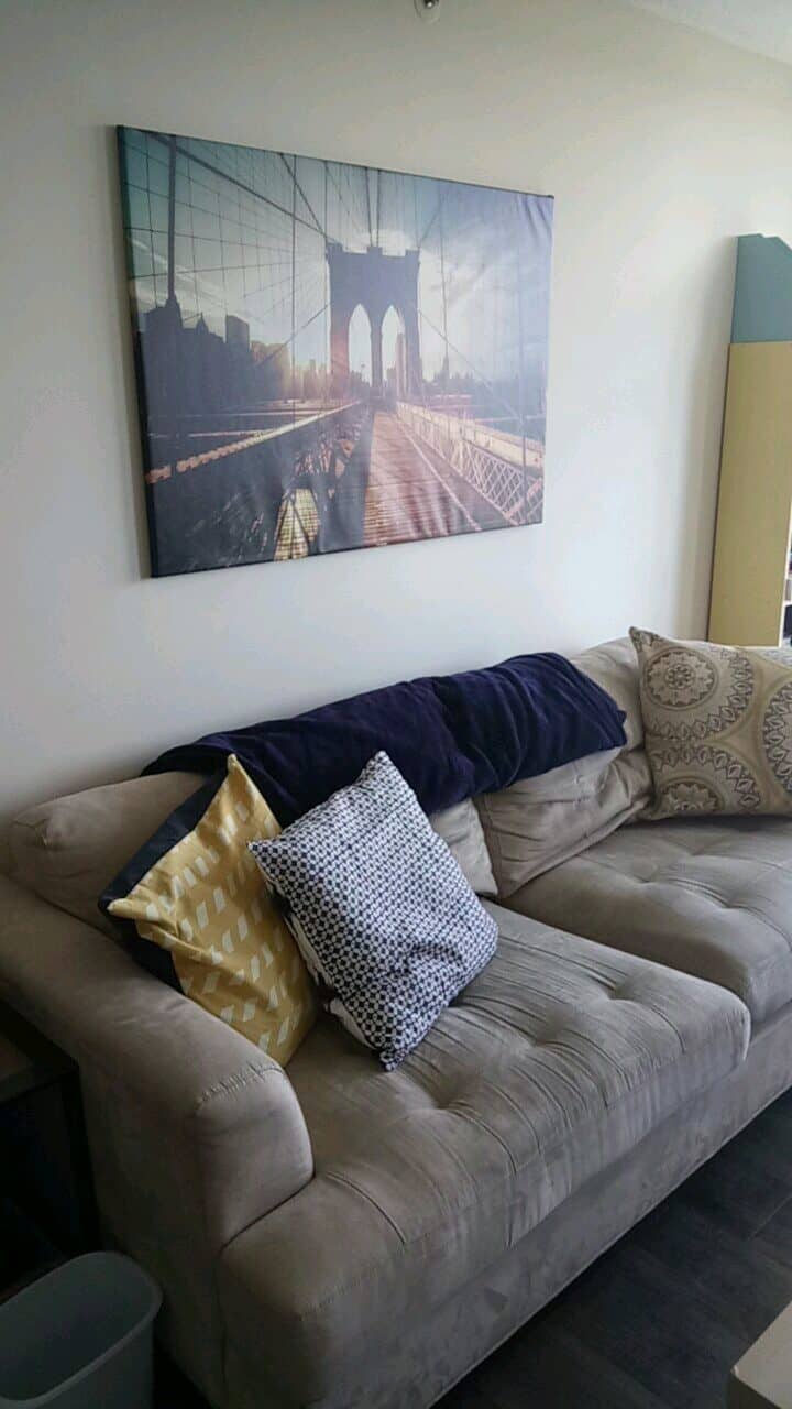 Welcome to Our Home in New Westminster, BC 14 Couch with cushions and Brooklyn Bridge photo above