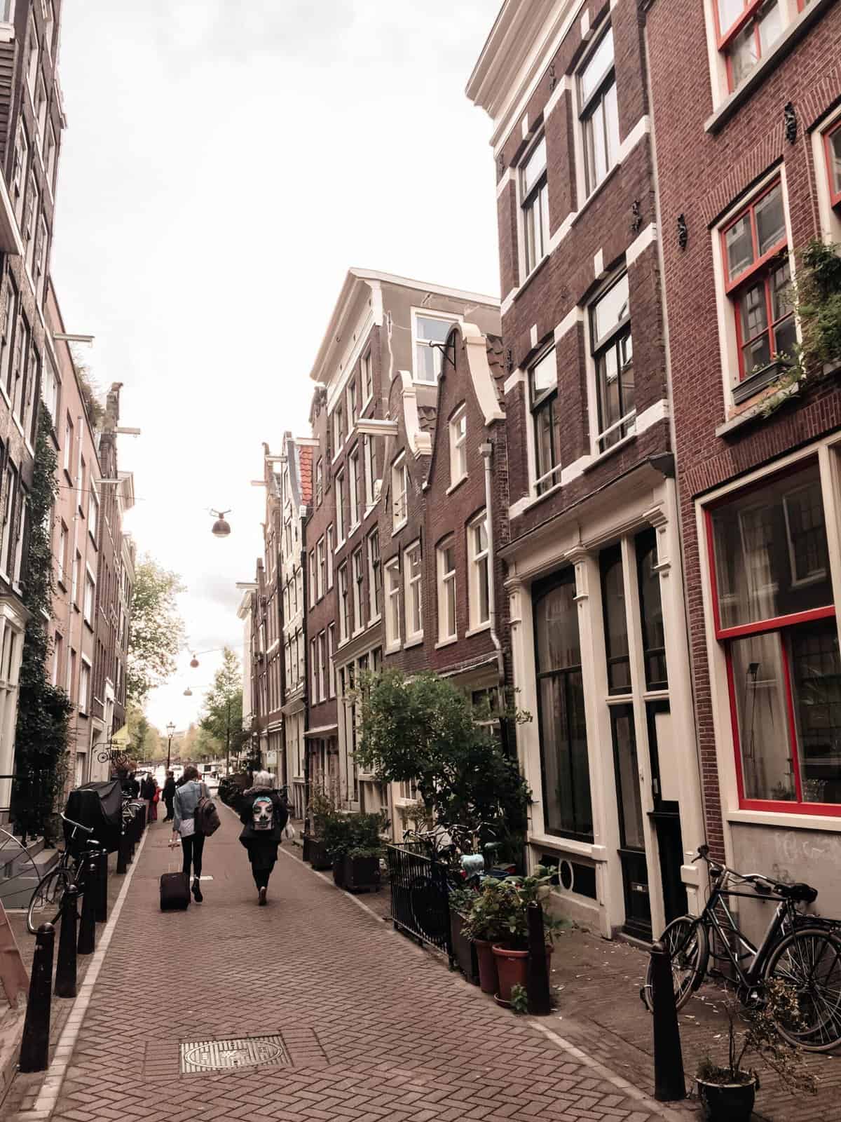 Falling Back in Love with Amsterdam 6 The characteristic skinny Dutch homes seen in an alleyway in Amsterdam, the Netherlands
