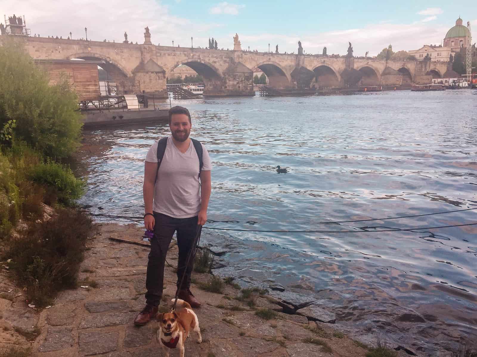 8 Things I Miss About Living in Prague 23 Colin and our dog, Ellie, standing on the back of the Vltava River with Prague Charles Bridge in the background