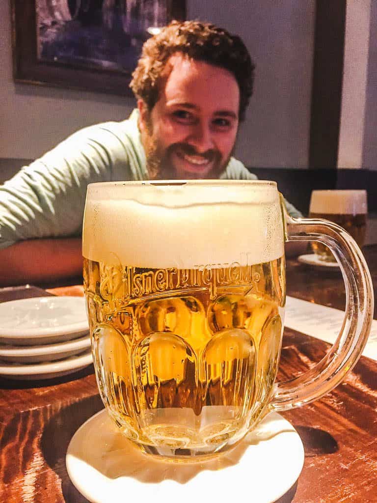 8 Things I Miss About Living in Prague 16 Colin smiling behind a pilsner beer mug in Prague