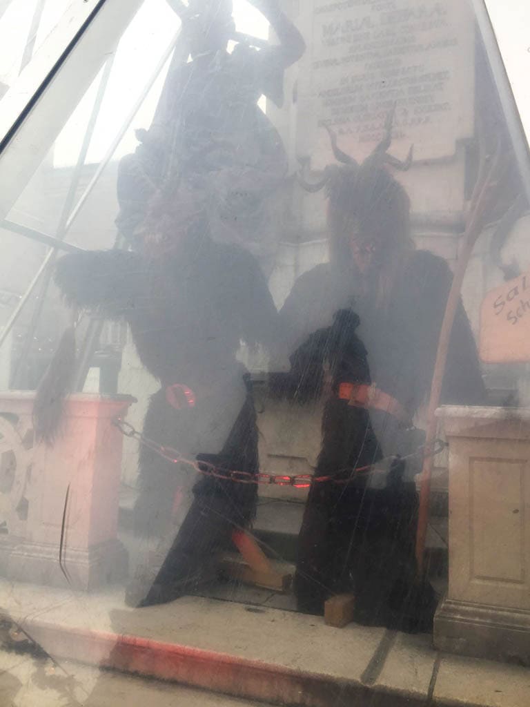 The Ultimate European Christmas Market Road Trip 35 Krampus locked up behind glass at the Salzburg Christmas Markets
