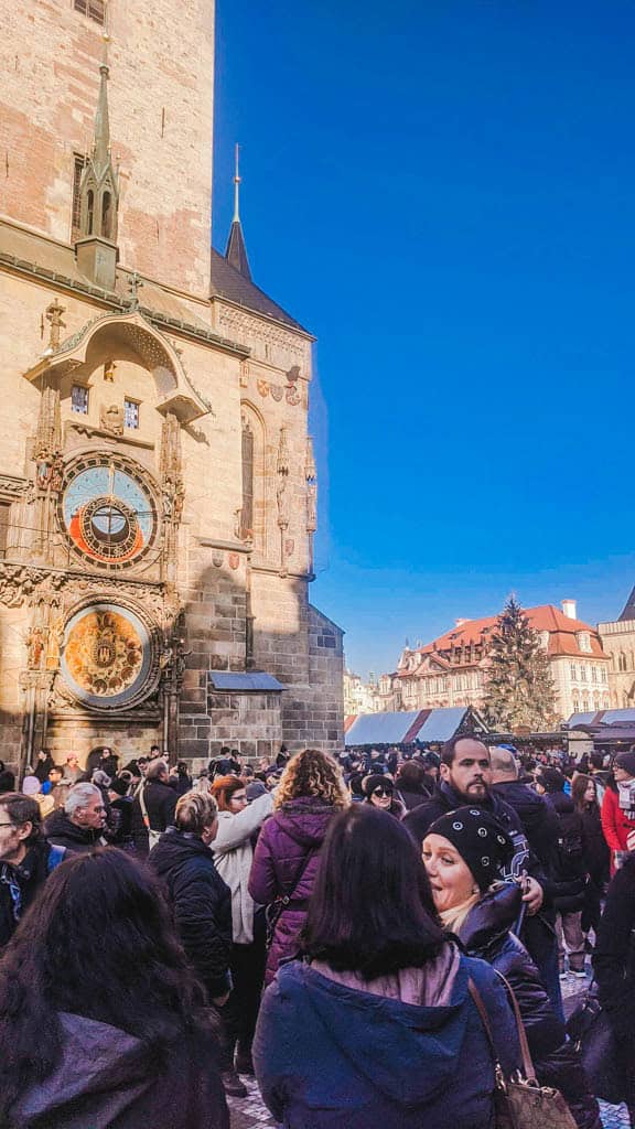 The Ultimate European Christmas Market Road Trip 10 Old Town Square Christmas Market in Prague with the Astronomical Clock, crowds and a Christmas tree in the background