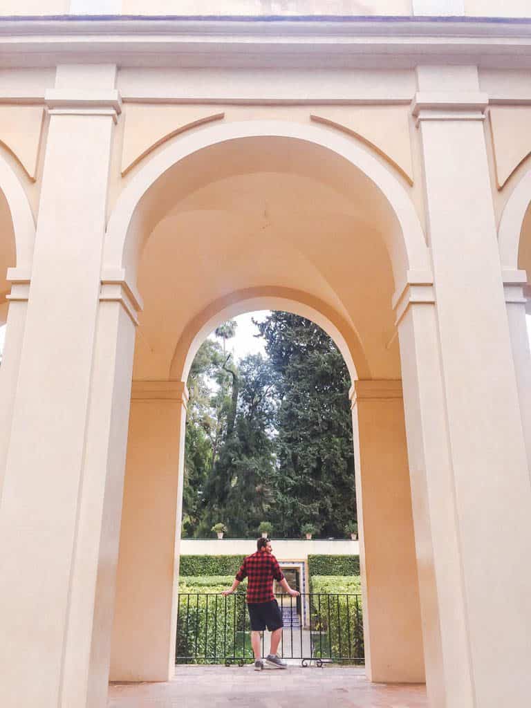 Falling in Love with Seville 25 Colin posing in front of an archway at the Royal Alcazar of Seville