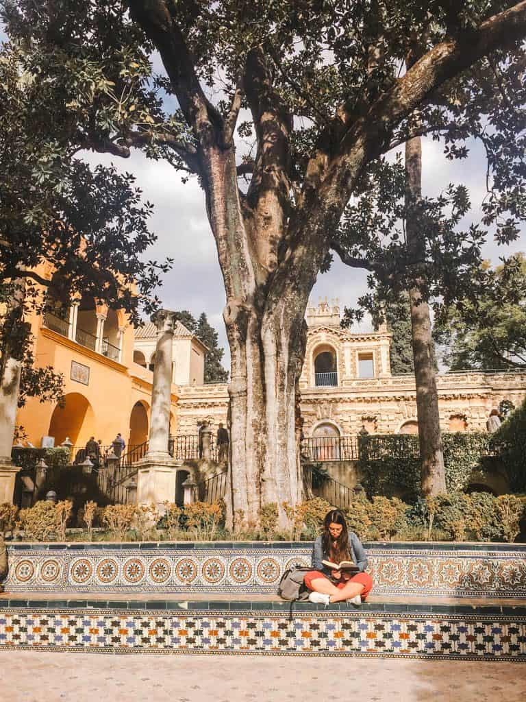 Falling in Love with Seville 22 Jade reading her book on a bench at the Royal Alcazar of Seville