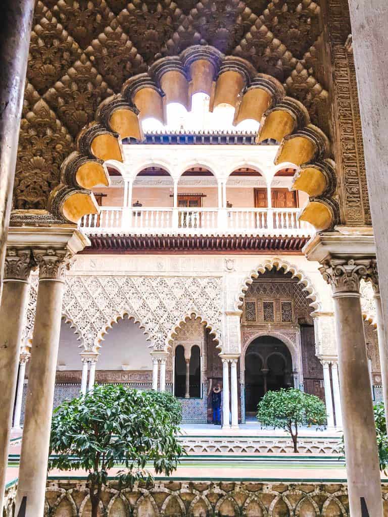 Falling in Love with Seville 26 An archway featuring Arabic architecture and tiles inside the Royal Alcazar of Seville