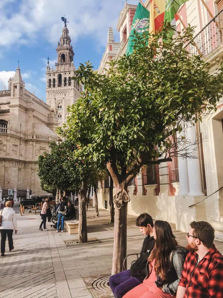 Falling in Love with Seville 29 Colin, Jade and Lee sitting on a bench and enjoying the views in Seville, Spain