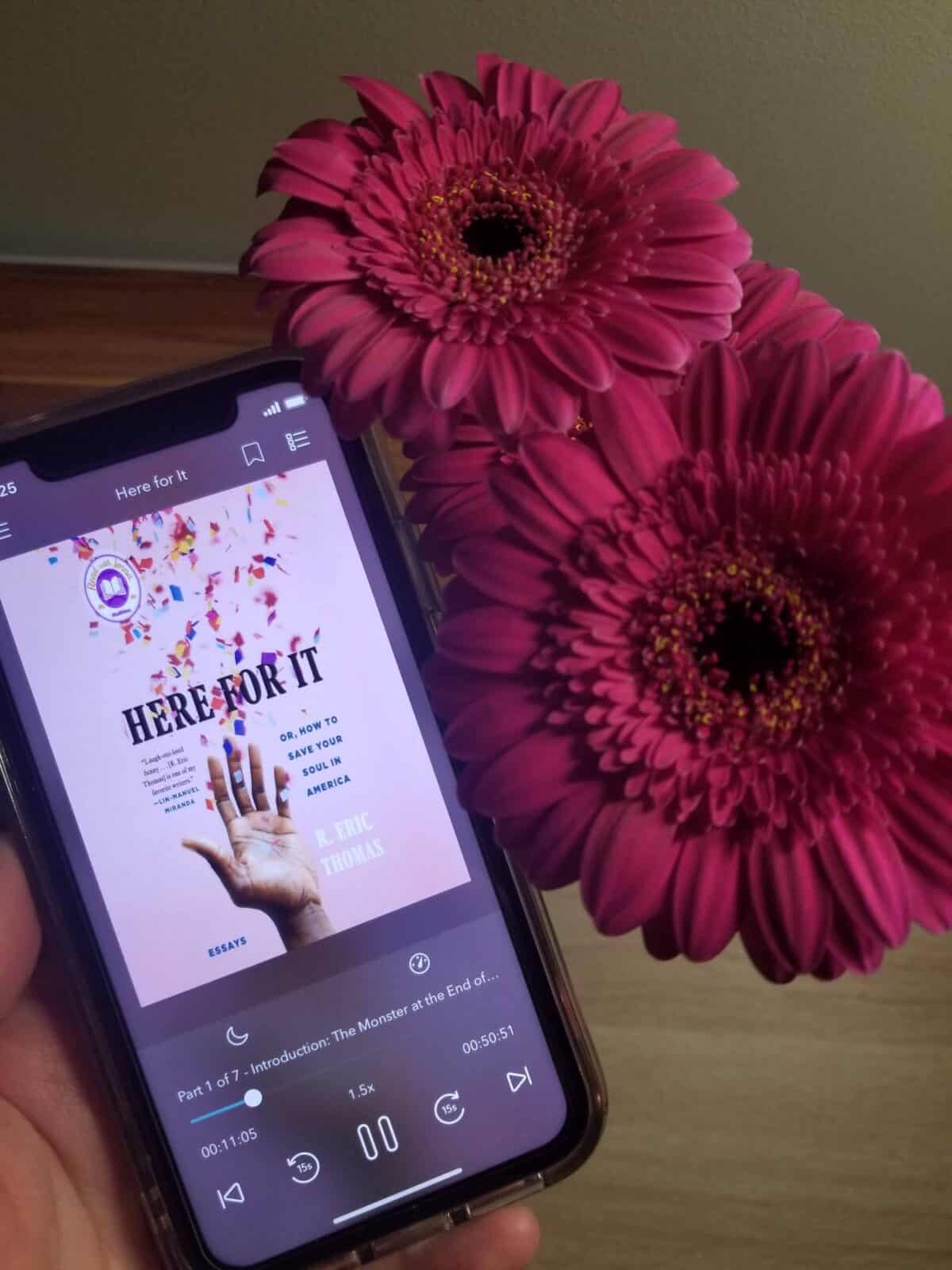 40+ Beach Reads for Every Reading Mood 14 Audiobook of Here for It by R. Eric Thomas next to pink daisies