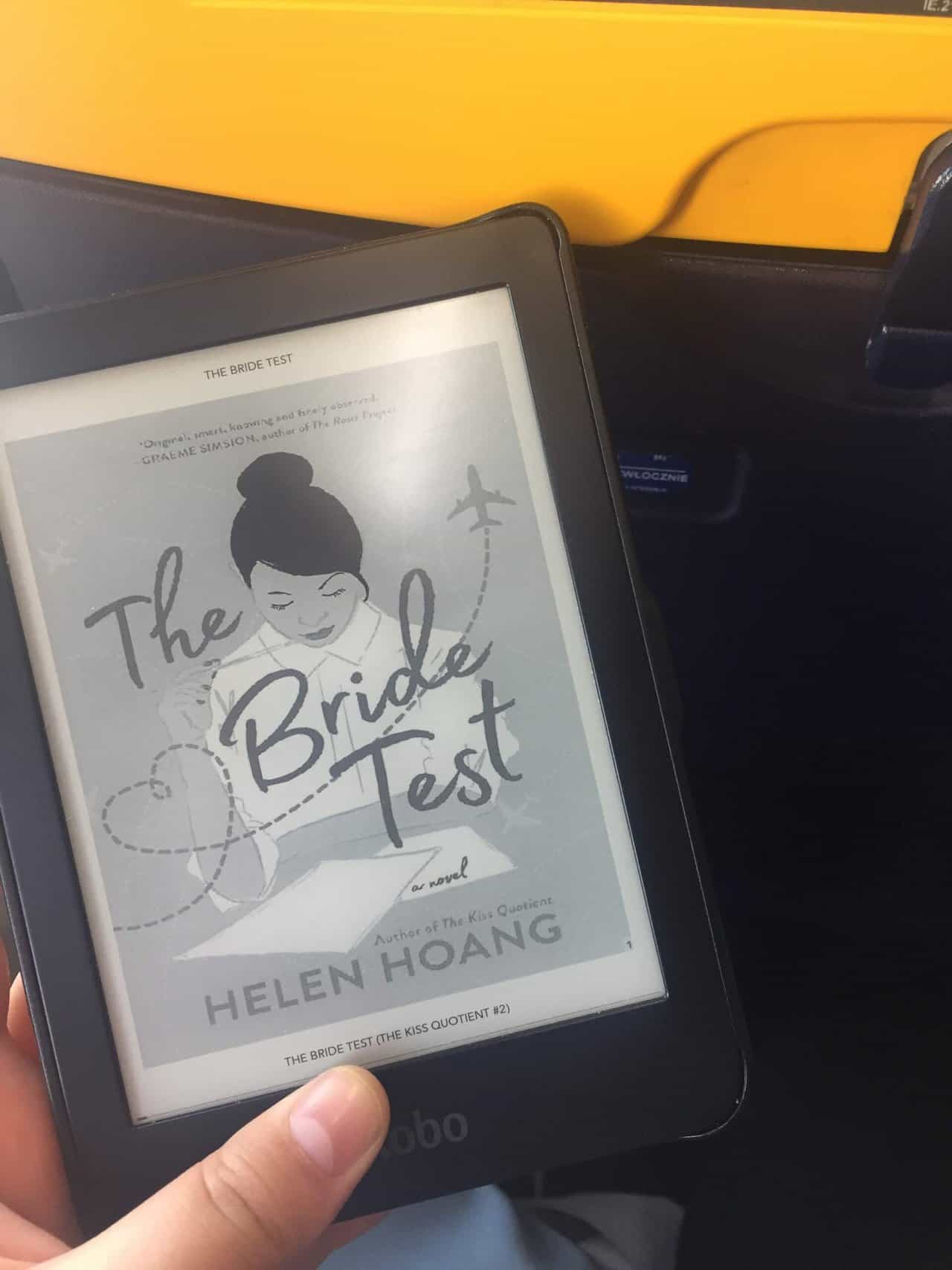 40+ Beach Reads for Every Reading Mood 9 Riana holding the ebook of The Bride Test