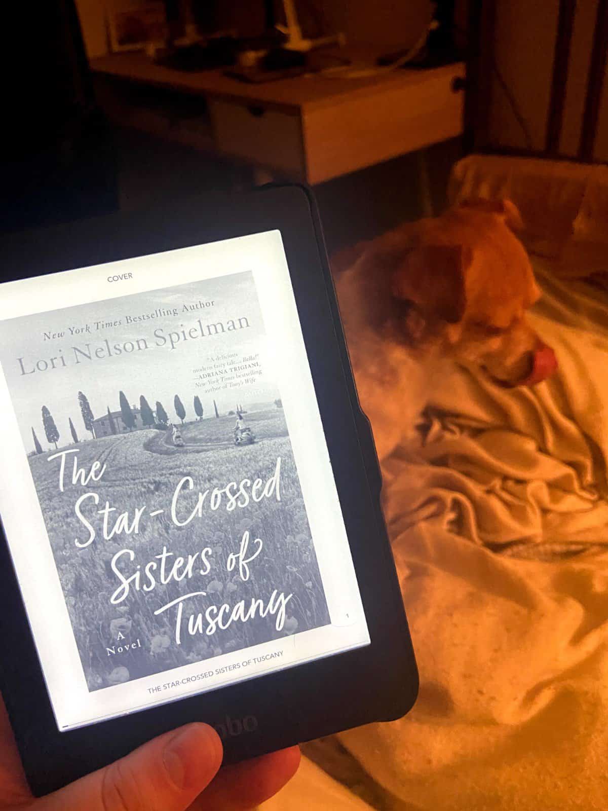 40+ Beach Reads for Every Reading Mood 6 Riana holding the ebook of The Star-Crossed Sisters of Tuscany by Lori Nelson Spielman
