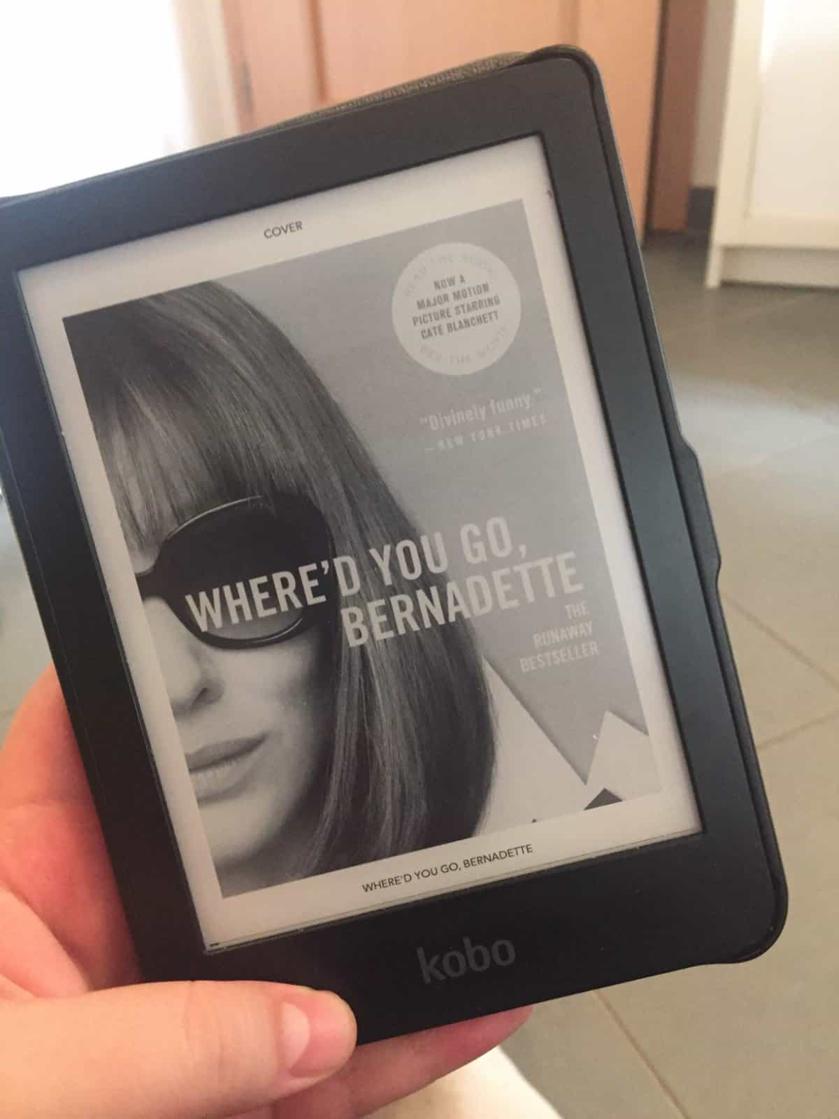 40+ Beach Reads for Every Reading Mood 8 Riana holding the ebook of Where'd You Go Bernadette
