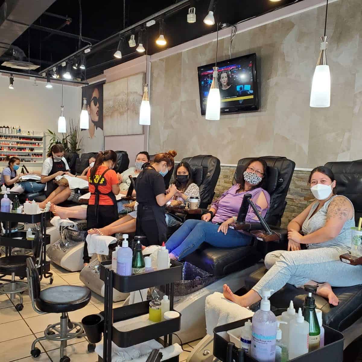 Which Wedding Traditions Did We Actually End Up Skipping? 4 Riana and her family members smiling from spa chairs while they get manicures and pedicures