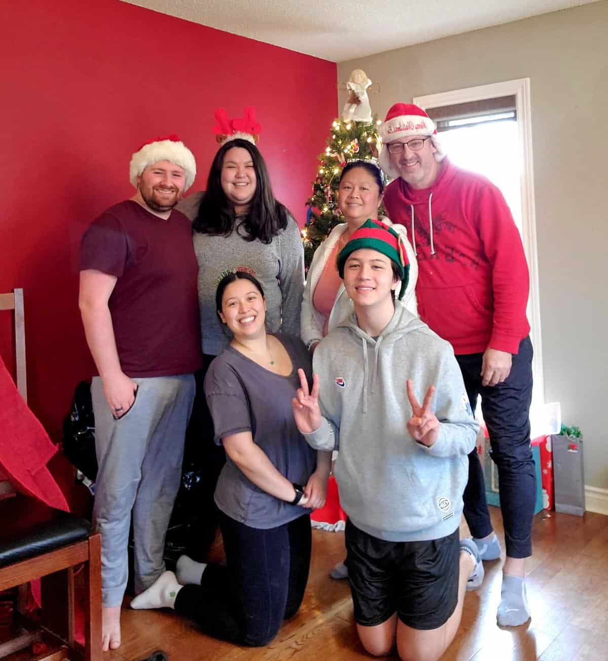 family in front of the christmas tree in toronto for christmas 2021