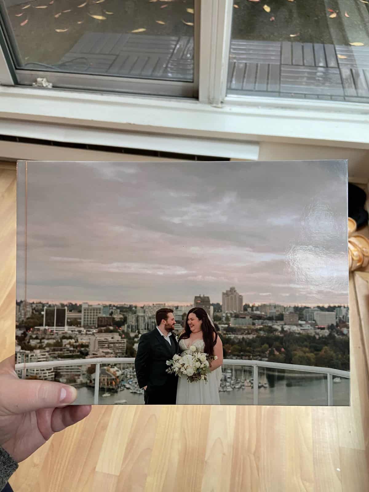 Riana holding a wedding photo album made with the Vistaprint online photo book service