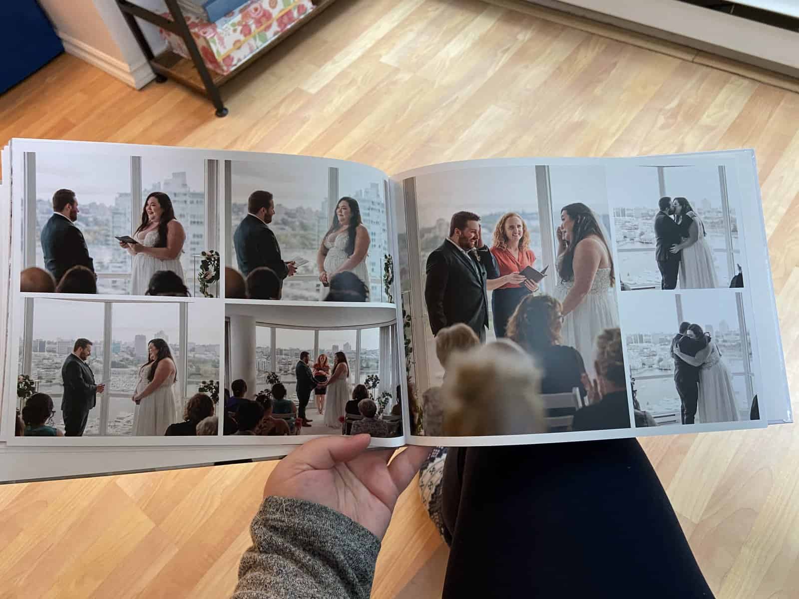 Riana holding a wedding album open to ceremony photos, book made using Vistaprint online photo book maker