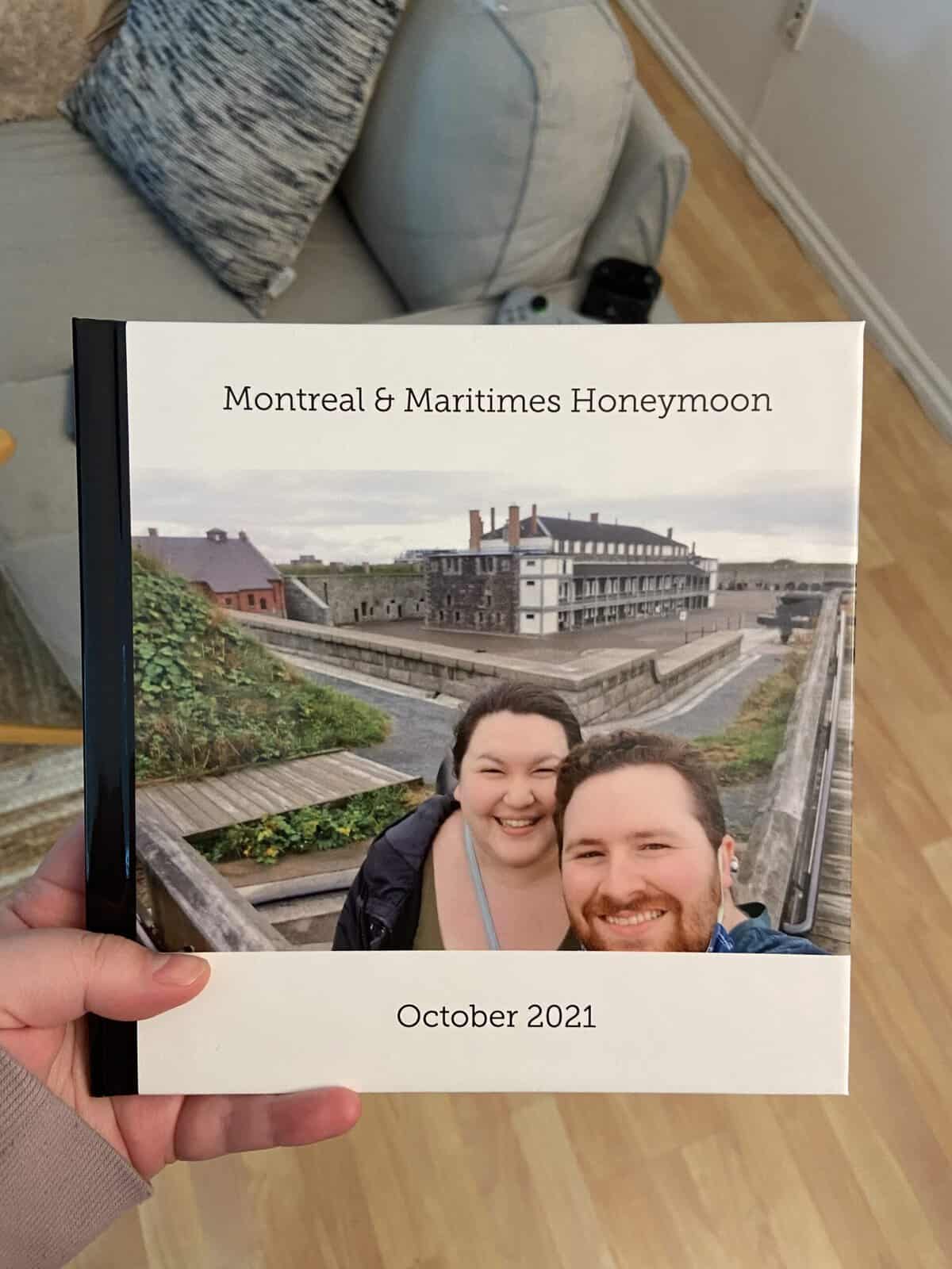 Riana holding a copy of her honeymoon photo book made using Shutterfly online photo book service