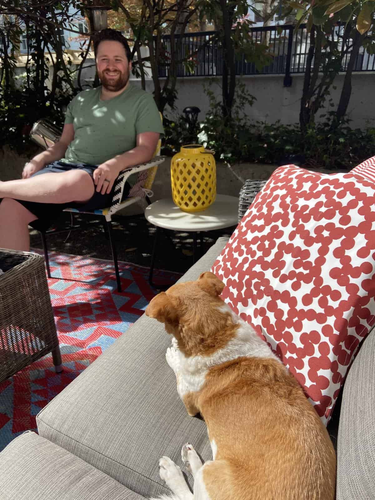 Our Budget Patio Makeover 15 sitting on outdoor couch with dog