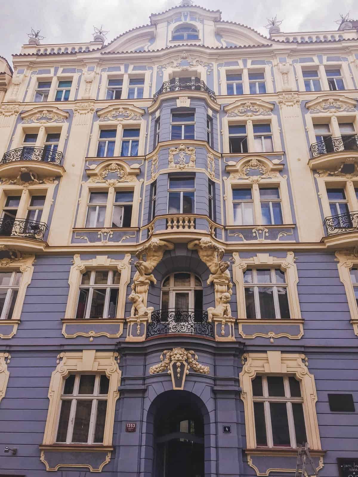 8 Things I Miss About Living in Prague 6 A beautiful purple blue building with white detailign in Vinohrady, Prague