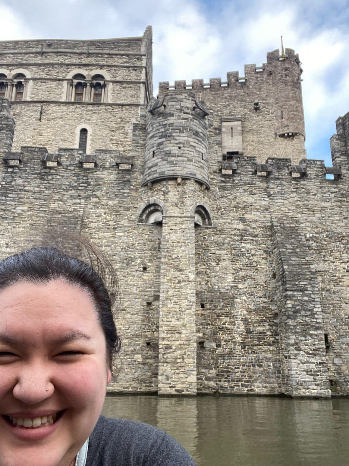 11+ Stunning Things to Do in Ghent, Belgium 28 Riana selfie of Gravensteen from a Ghent boat cruise