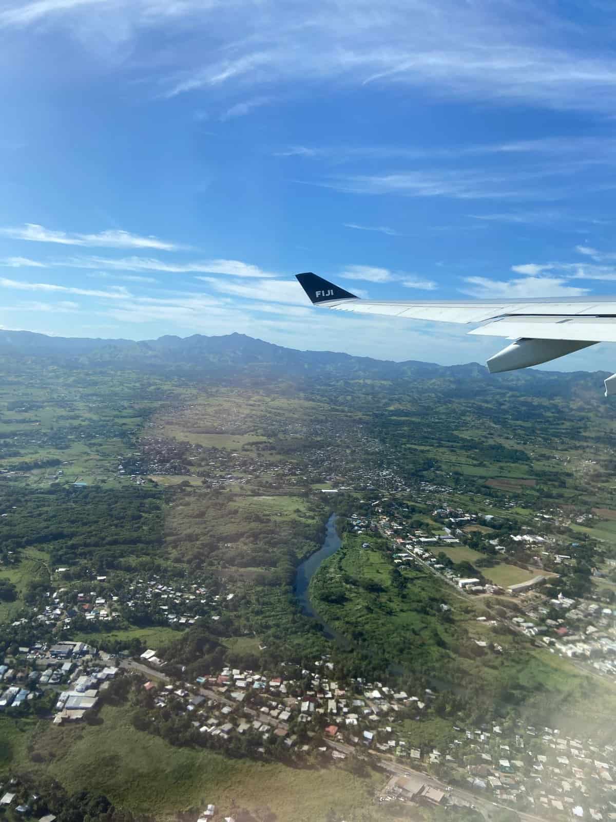 19 Things to Know Before You Plan a Trip to New Zealand 5 Fiji Airways plane wing flying over Fiji on the way to New Zealand