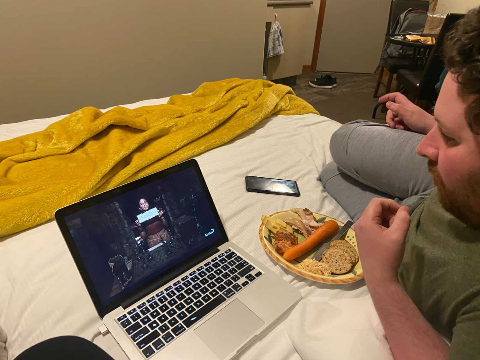 Watching Survivor and eating dinner in bed at Aoraki Mount Cook hotel in New Zealand
