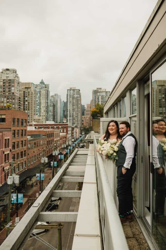 posing on the balcony of the Opus Hotel in Vancouver on our wedding day