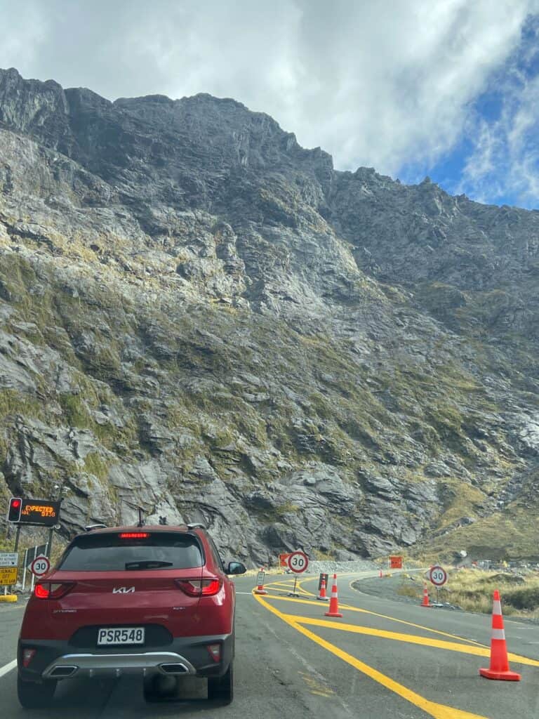 Cars waiting to go through the Homer Tunnel on the way to Milford Sound, New Zealand