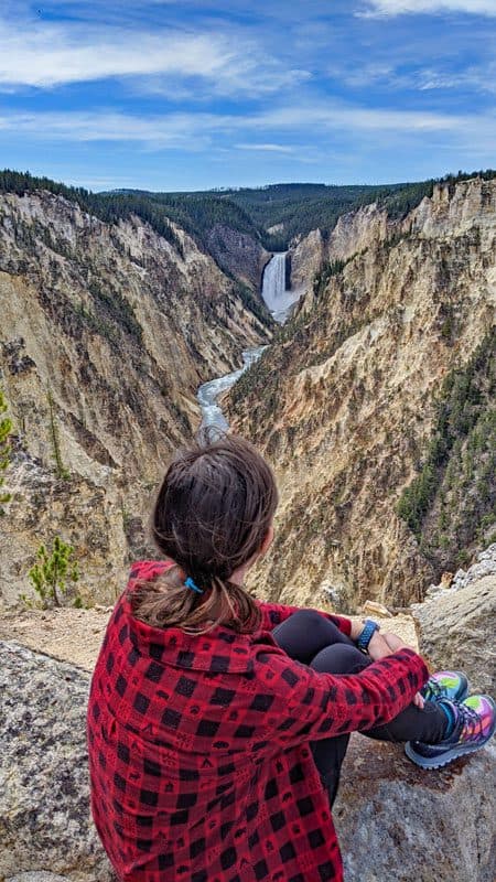 Kris sitting at Artists Point mountain in flannel
