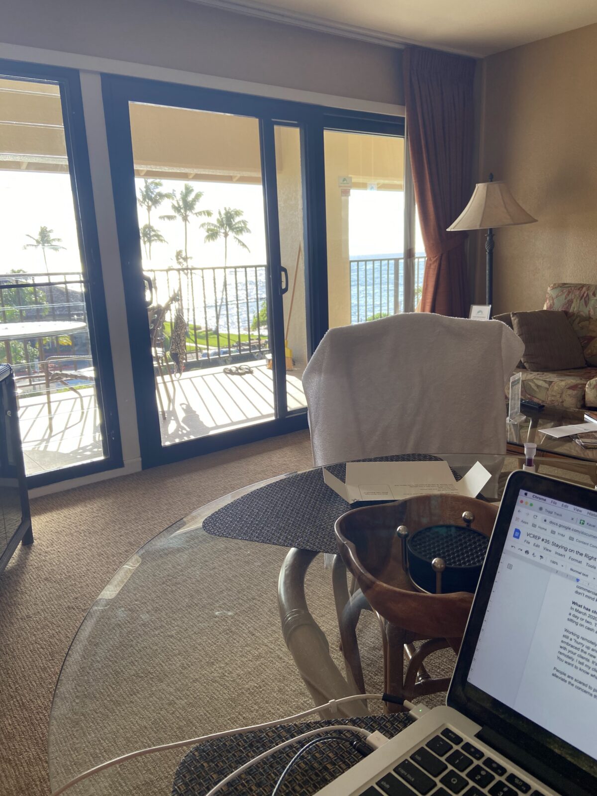18 Freelancer Tips for Beginners (From an 8 Year Veteran!) 6 Laptop on a desk with a view of the balcony behind it at a resort in Hawaii