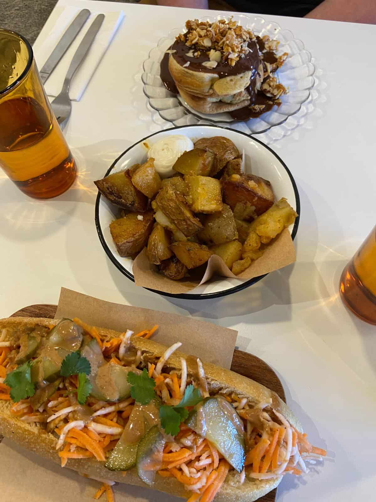 The Perfect 5 Day Provence Itinerary 23 Three dishes enjoyed for brunch in Aix-en-Provence; a banh mi sandwich, a bowl of potatoes, and pancakes covered in chocolate sauce
