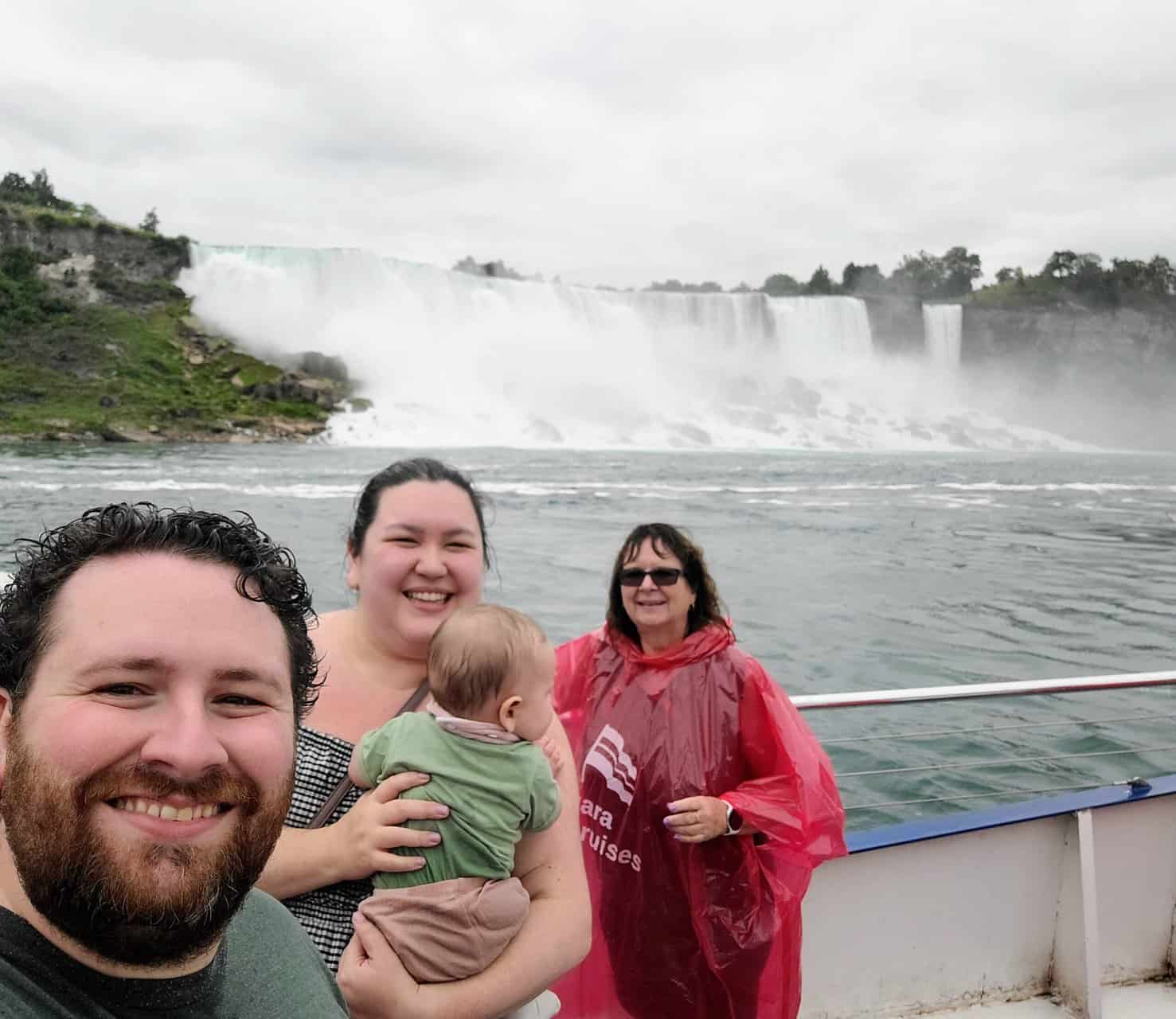 Riana and her family in front of the American Falls after finishing their Niagara City Cruise
