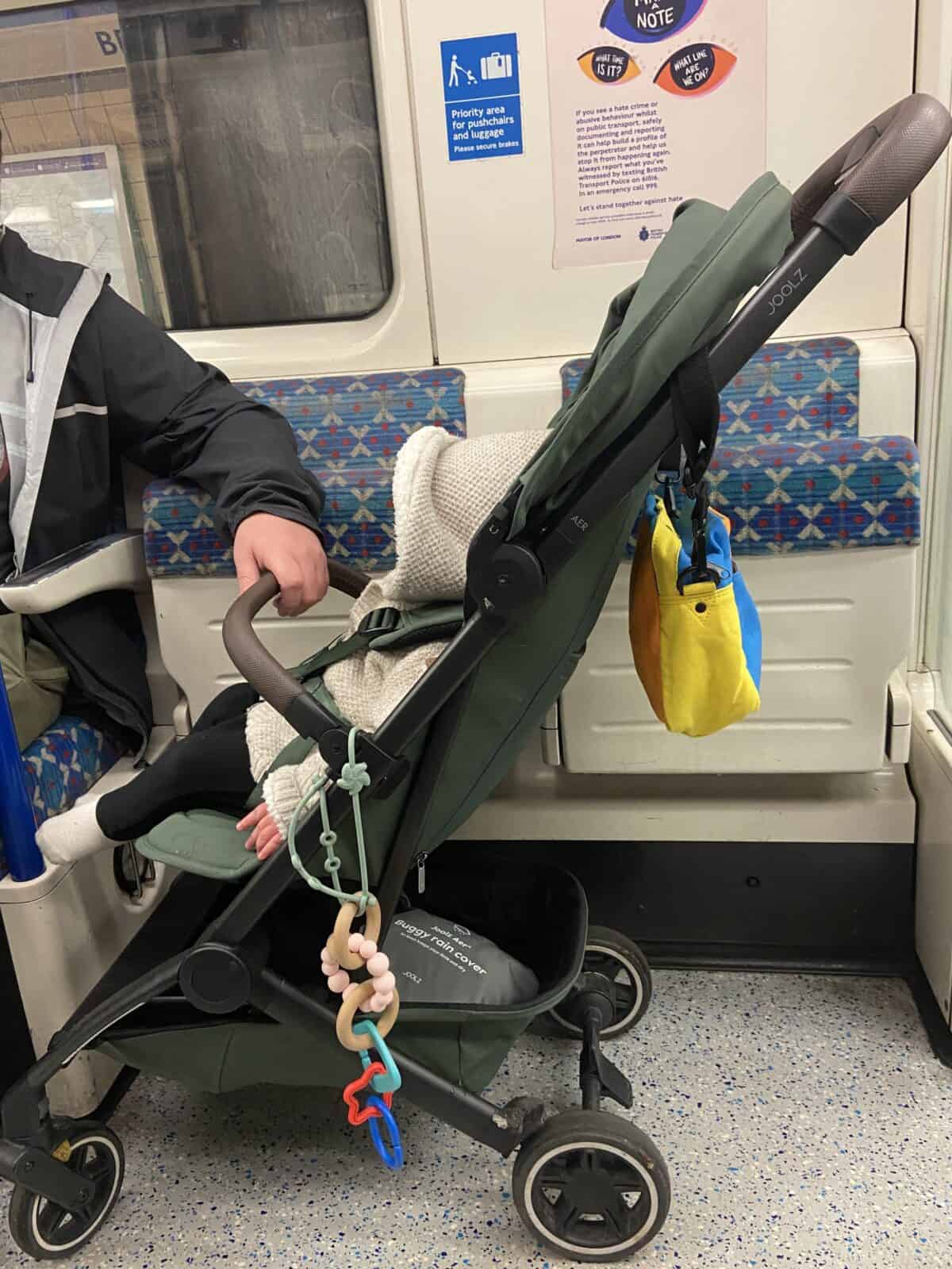 Joolz Aer Review: Is This the Best Travel Stroller? 8 Baby C sitting in her Joolz Aer travel stroller while riding on the London Underground