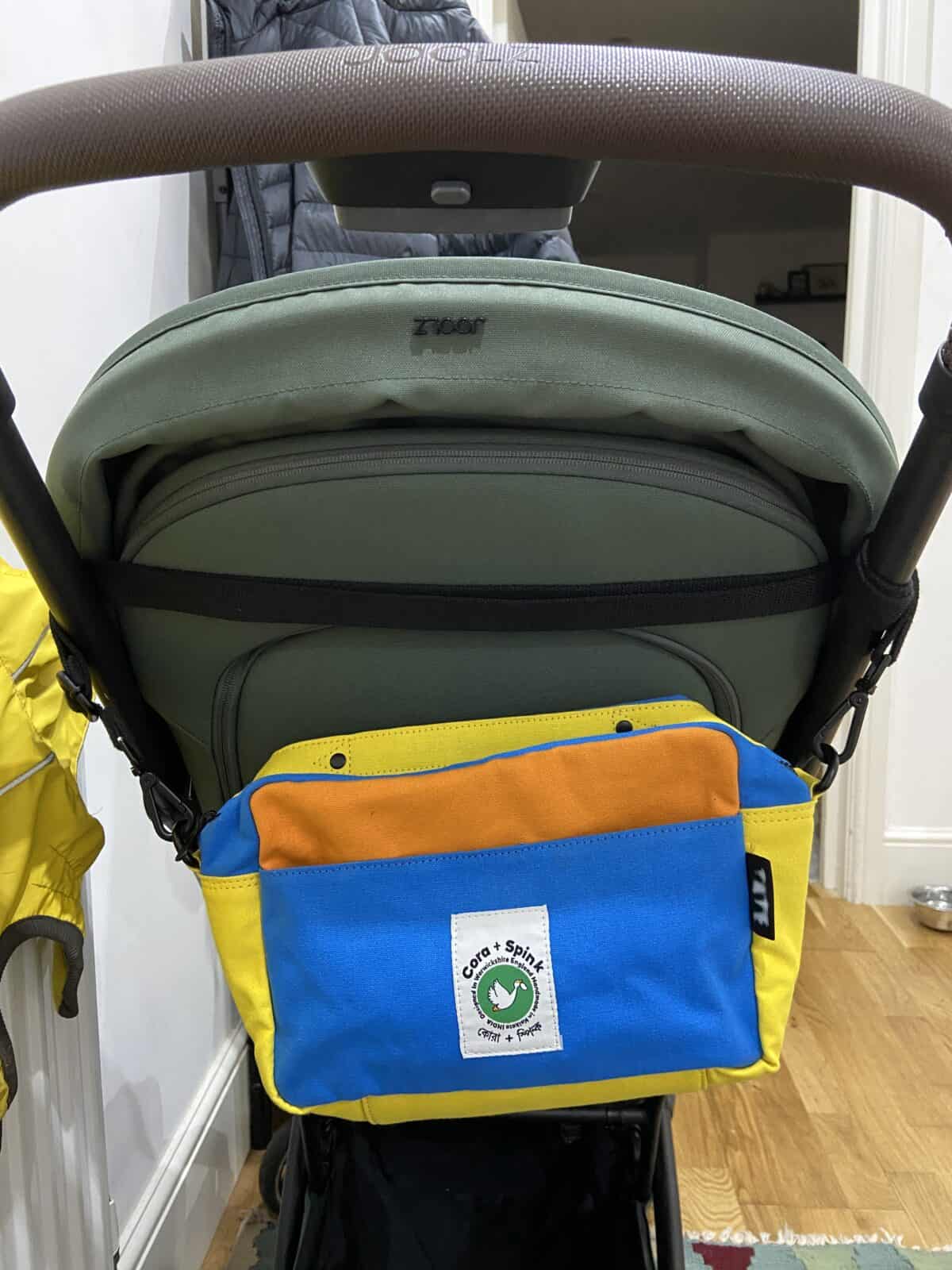 Our Essential Packing List for Travel with a Baby 29 Our mini diaper bag on the back of Baby C's stroller
