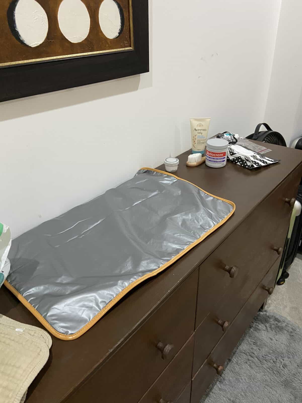Our Essential Packing List for Travel with a Baby 28 Our travel baby change station with a diaper change pad, diaper rash cream and other toiletries