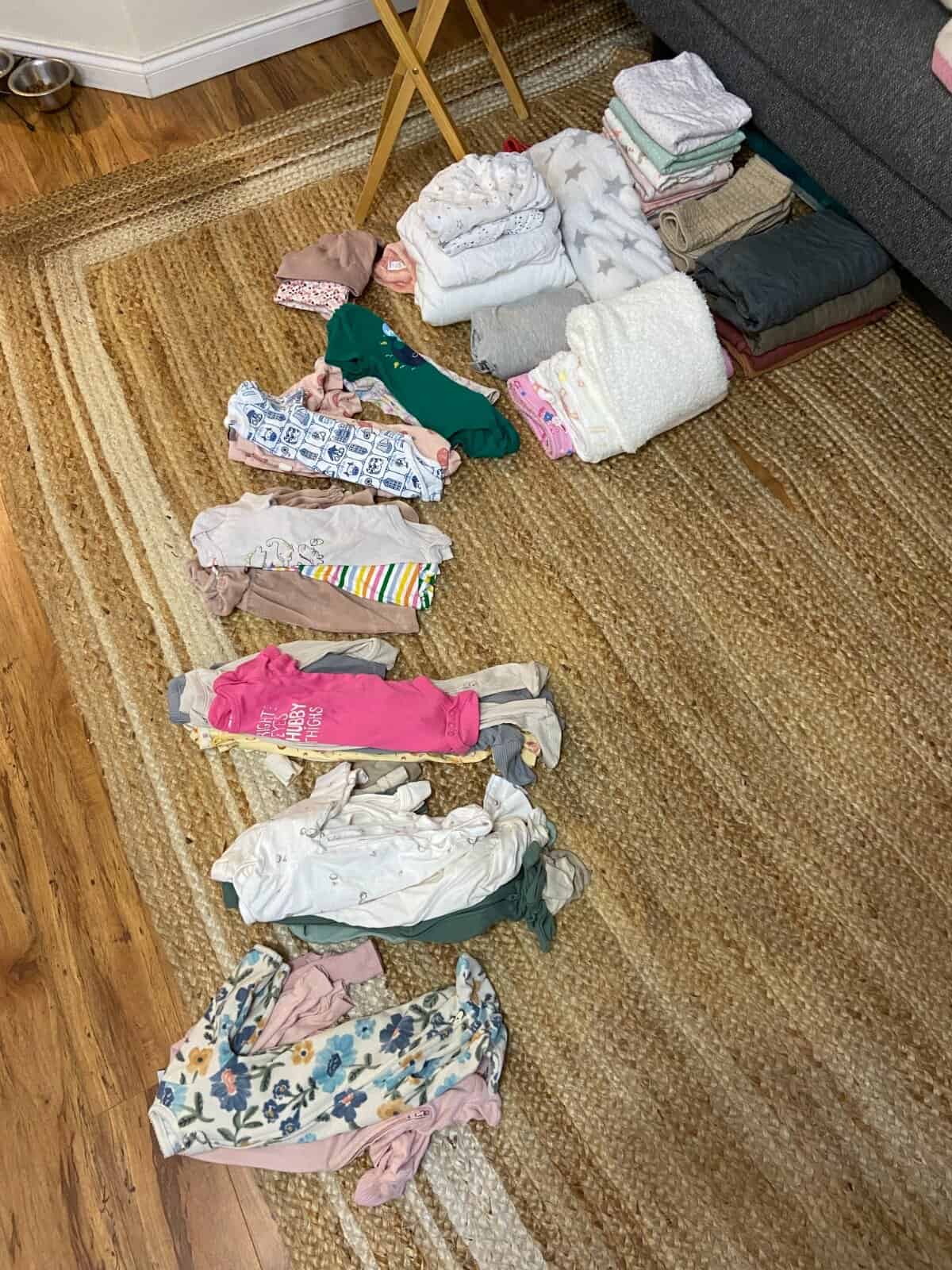 Our Essential Packing List for Travel with a Baby 22 Sorting through baby clothing to decide what makes the cut for our baby travel packing list