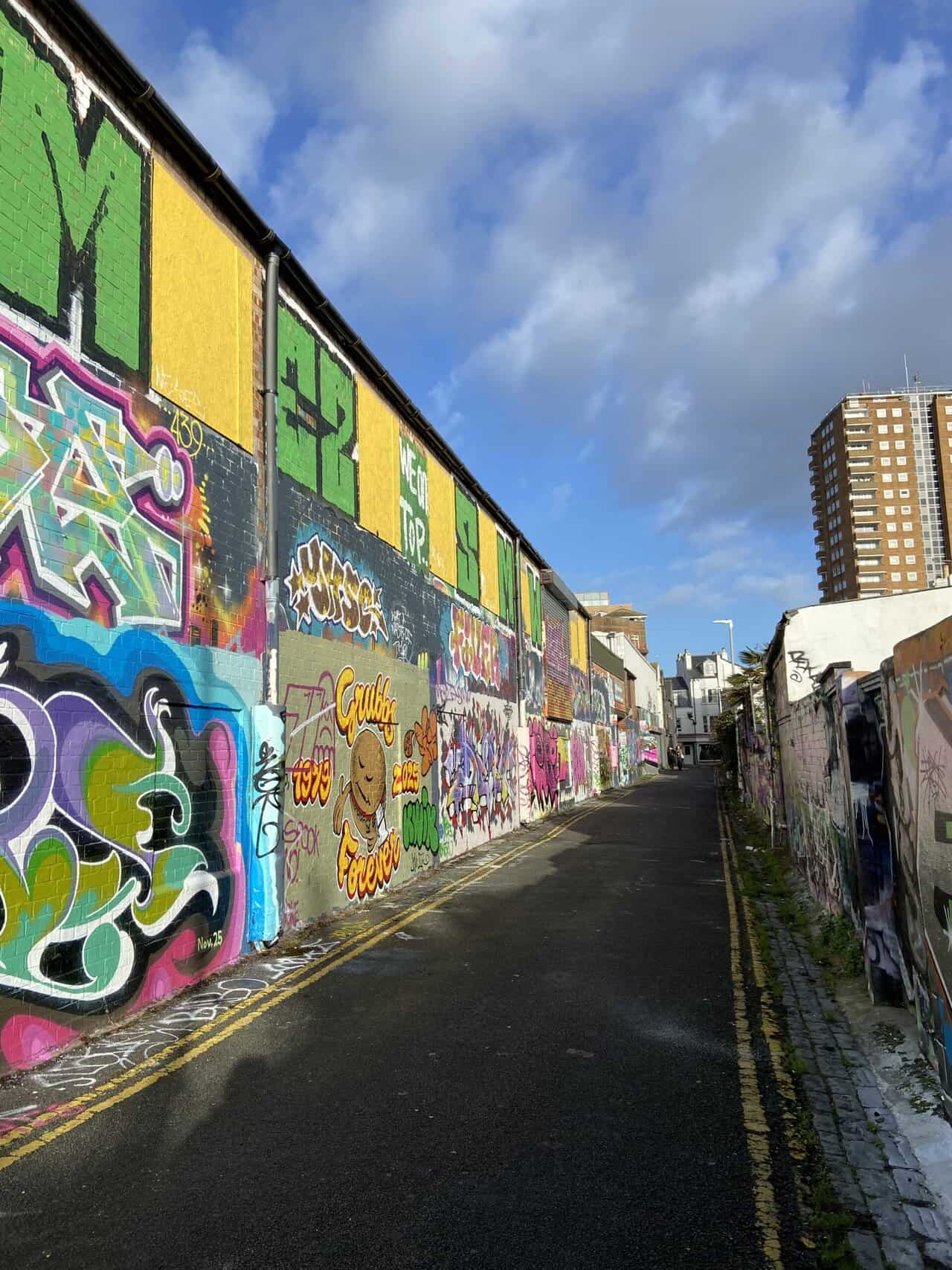 Sun shining on an alley covered in graffiti street art where we were living in Brighton England