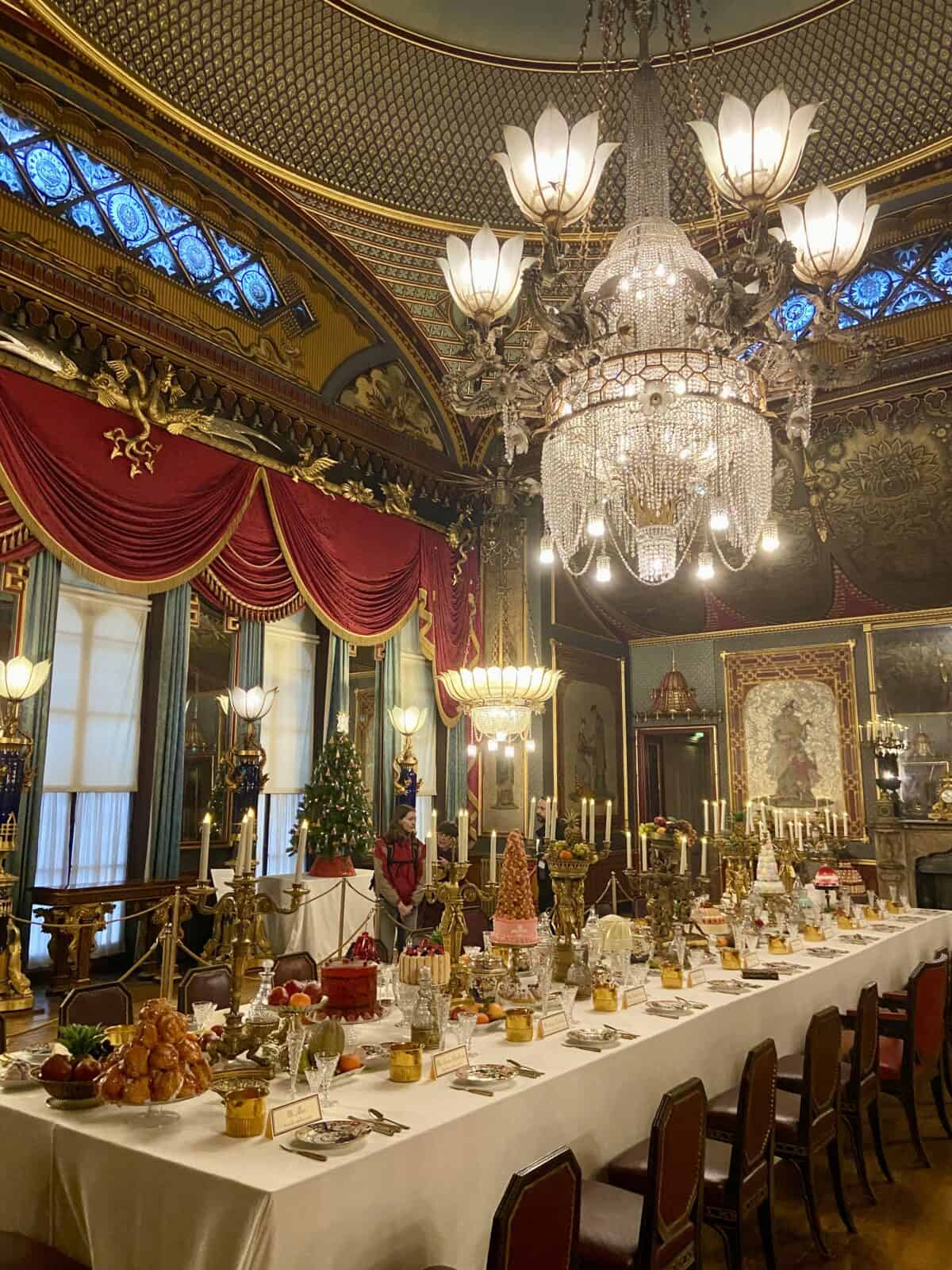 Your Guide to Brighton's North Laine 21 Dining room inside Brighton Royal Pavilion with ornate chandelier, long table and red curtains