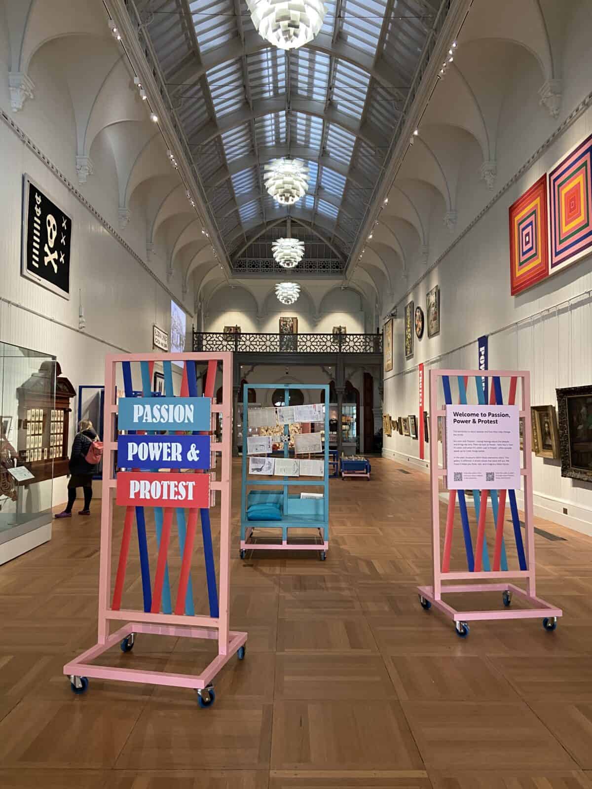 Your Guide to Brighton's North Laine 22 Art exhibit in a long room with tall ceilings inside the Brighton Museum and Art Gallery