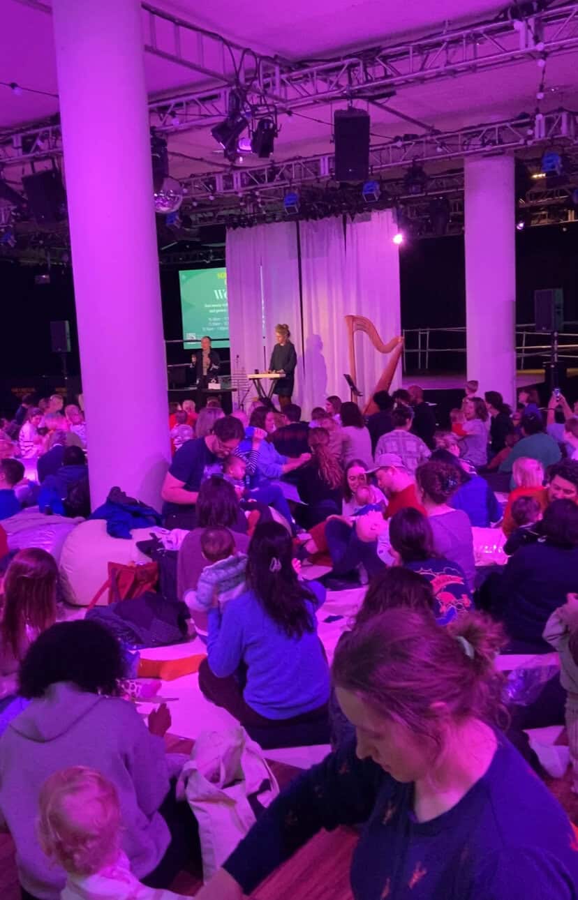 20+ Things to Do in London With a Baby 6 Parents and their babies seated on the floor of a ballroom in the Southbank Centre for Wordplay, a free music session for babies in London