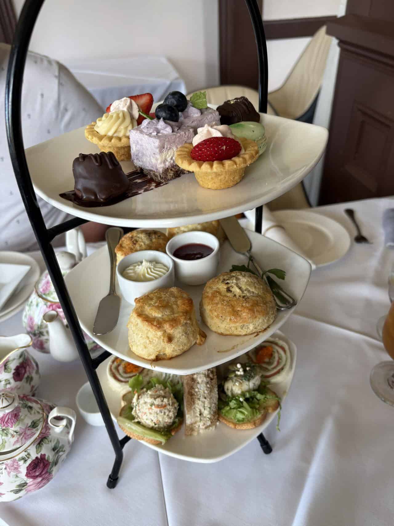 Pendray Tea House Review: Afternoon Tea in Victoria, BC 7 Three tier stand of the traditional afternoon tea and the west coast afternoon tea at Pendray Tea House in Victoria. The stand has pastries and desserts on the top, scones in the middle, and savoury bites on the bottom.