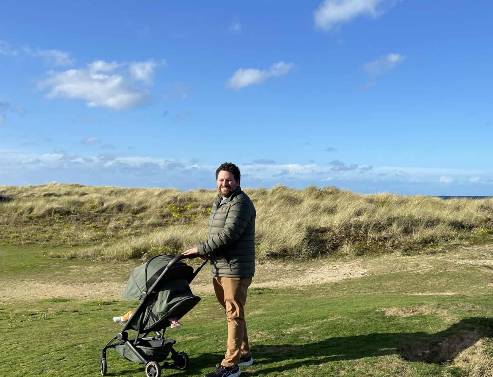 Joolz Aer Review: Is This the Best Travel Stroller? 17 Colin pushing Baby C in her Joolz Aer stroller on the sand dunes at Juno Beach, Normandy, France