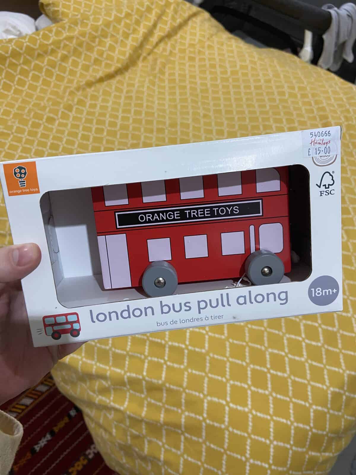 20+ Things to Do in London With a Baby 34 A wooden toy of a London red double decker bus with a pull string, purchased from Hamleys in London