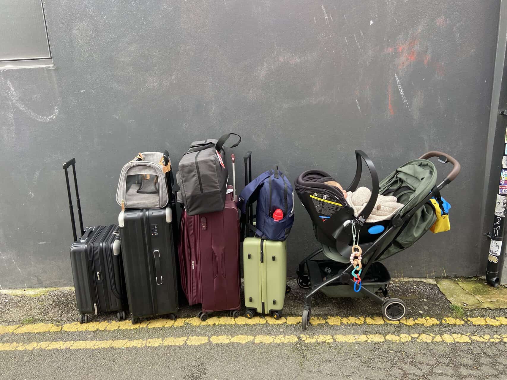 Joolz Aer Review: Is This the Best Travel Stroller? 6 All of our suitcases, backpacks, dog carrier, travel stroller and car seat lined up along a wall in Brighton, England