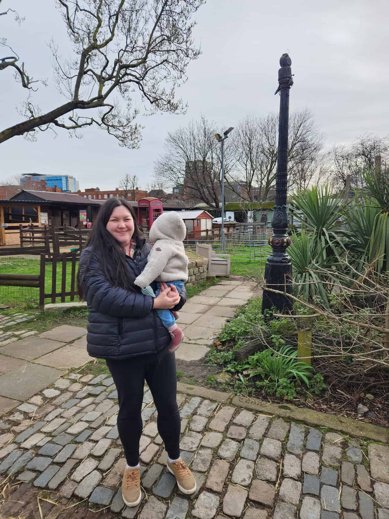 20+ Things to Do in London With a Baby 50 Riana holding Baby C at Spitalfields City Farm in London