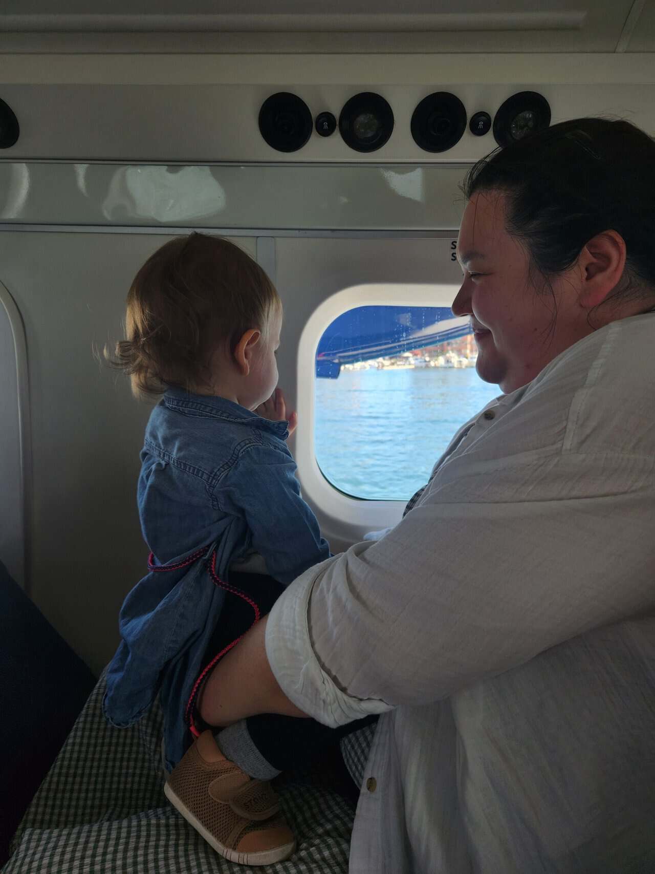 Should You Take a Seaplane to Victoria from Vancouver? (Harbour Air Review) 4 Riana smiling at Baby C who sits on her lap during a seaplane flight