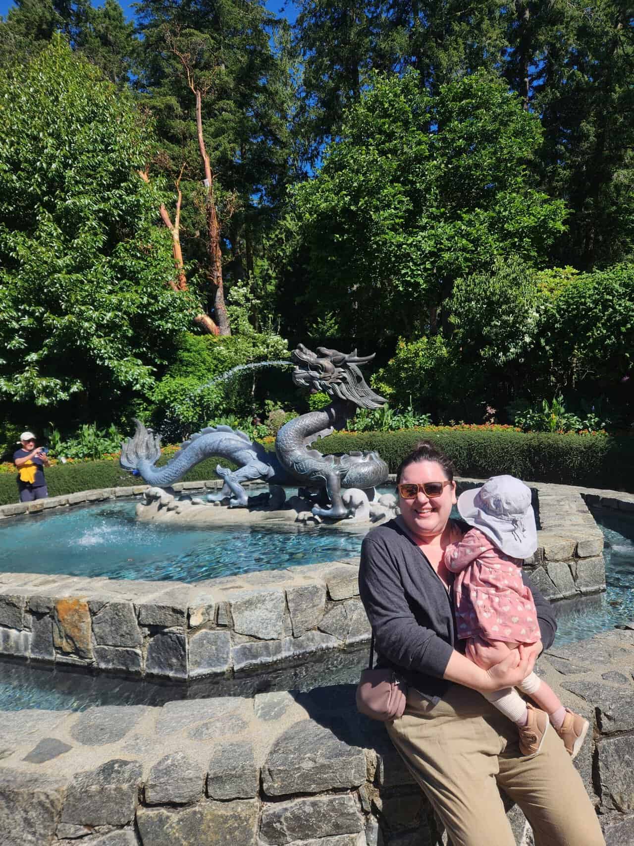 Riana and Baby C sitting in front of the Dragon Fountain at Butchart Gardens, Victoria